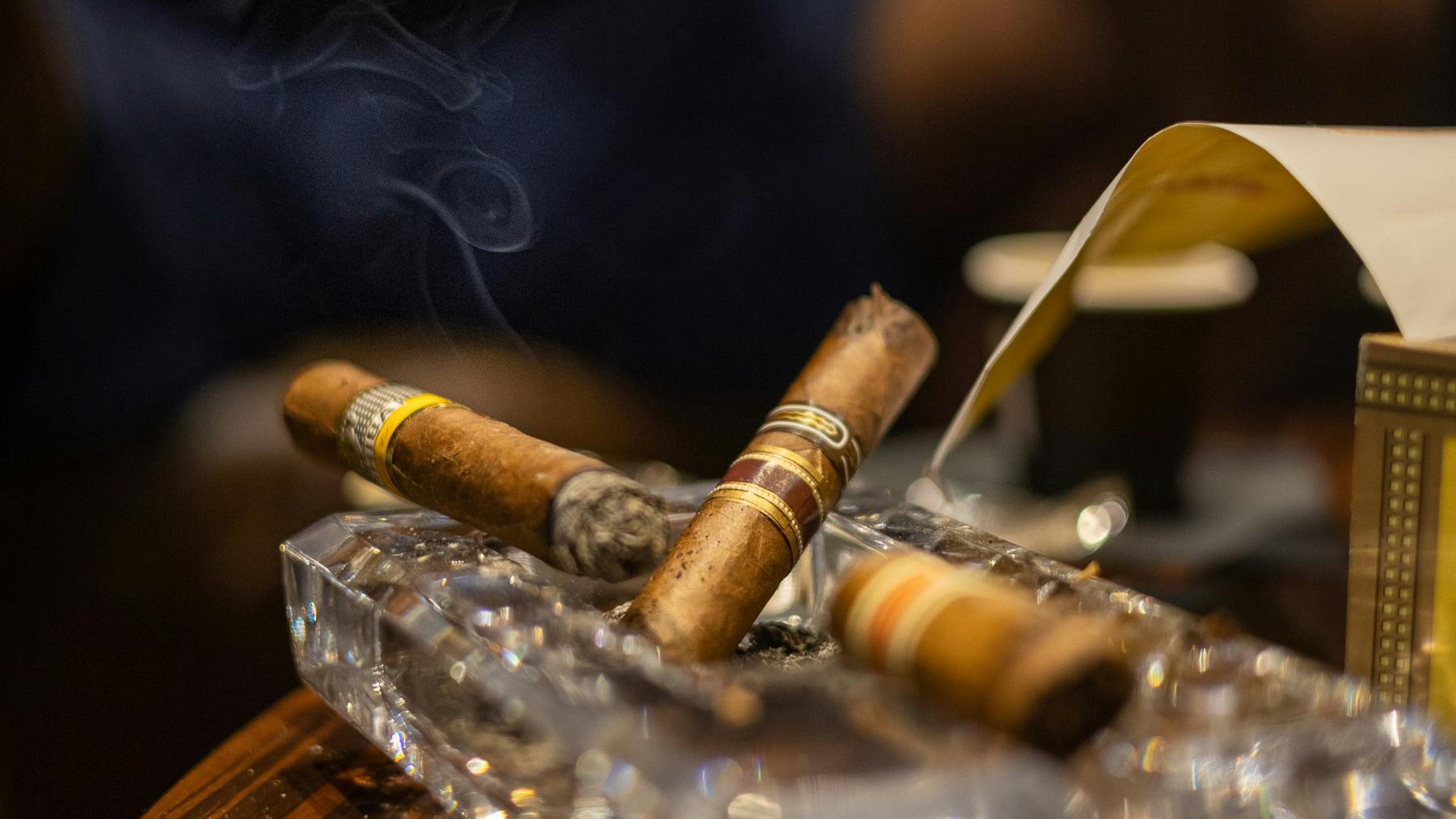 lit cigars in an ashtray